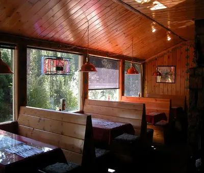 a dining room with two tables and two windows at StrawberryInn River Front Resort in Strawberry