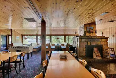 a dining room with tables and a fireplace at StrawberryInn River Front Resort in Strawberry