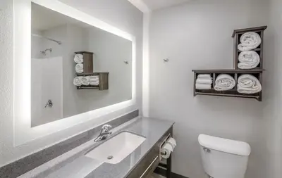 a white bathroom with a sink and a mirror at My Place Hotel-Carson City, NV in Carson City