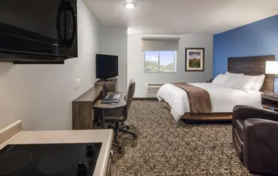 a hotel room with a bed and a flat screen tv at My Place Hotel-Carson City, NV in Carson City