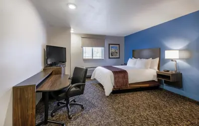 a hotel room with a bed and a desk and a computer at My Place Hotel-Carson City, NV in Carson City
