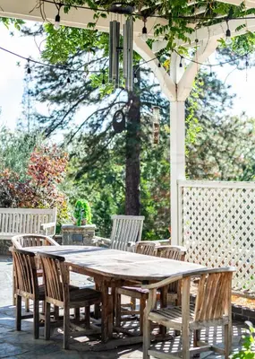 a wooden table and chairs on a patio at Inn at Sugar Pine Ranch in Groveland