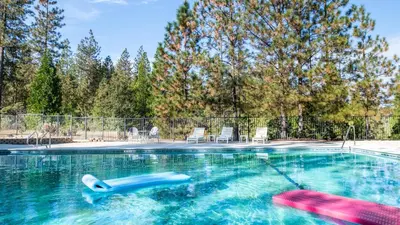 a swimming pool with a pool noodle in the water at Inn at Sugar Pine Ranch in Groveland