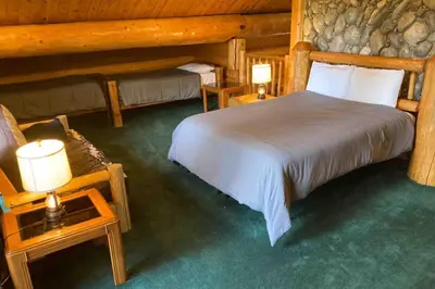 a bedroom with two beds in a log cabin at Vienna Villa - 3 Bed 3 Bath Vacation home in Shaver Lake in Shaver Lake