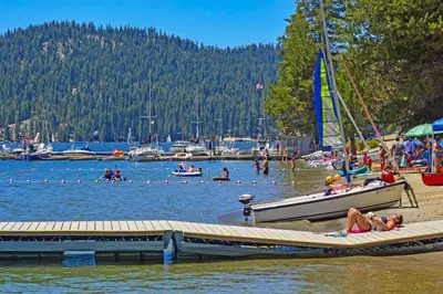 a group of people on a beach with a sail boat at Vienna Villa - 3 Bed 3 Bath Vacation home in Shaver Lake in Shaver Lake