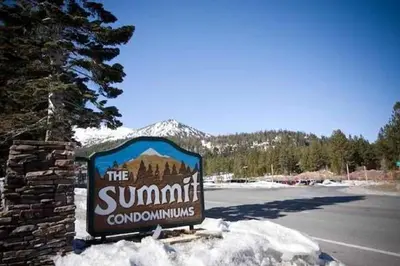 a sign for the summitcountrycountrycountrycountry sign in the snow at Summit by 101 Great Escapes in Mammoth Lakes