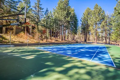 an outdoor basketball court with trees in the background at Summit by 101 Great Escapes in Mammoth Lakes