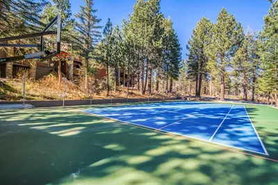 an outdoor basketball court with trees in the background at Summit by 101 Great Escapes in Mammoth Lakes