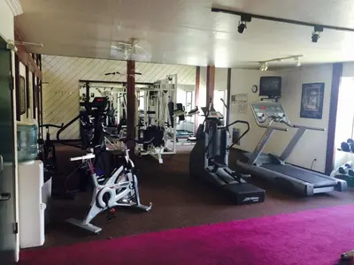 a gym with treadmills and cardio equipment in a room at Summit by 101 Great Escapes in Mammoth Lakes