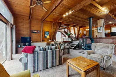 a living room with couches and a ceiling fan at Retro Family Gathering Home in Tahoe Donner in Truckee