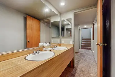 a bathroom with two sinks and a large mirror at Retro Family Gathering Home in Tahoe Donner in Truckee