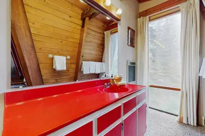 a red bathroom with a red sink and a window at Retro Family Gathering Home in Tahoe Donner in Truckee