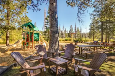 a park with chairs and a playground at Tahoe Donner Tree House Retreat in Truckee