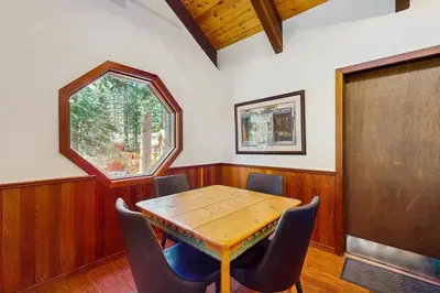 a dining room with a wooden table and chairs at Tahoe Donner Tree House Retreat in Truckee