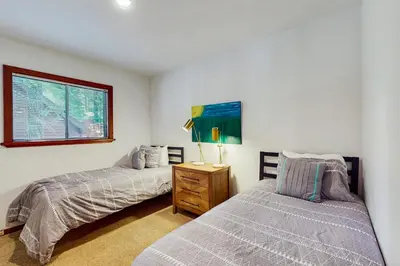 a bedroom with two beds and a window at Tahoe Donner Tree House Retreat in Truckee