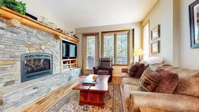 a living room with a couch and a fireplace at Mammoth Green #120 Condo in Mammoth Lakes