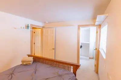 a small bedroom with a bed and a door at Beautiful 3500sf Lake Tahoe Home W/ Open Layout in Zephyr Cove