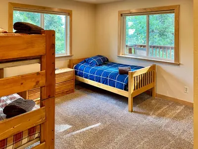 a bedroom with two bunk beds and two windows at Beautiful 3500sf Lake Tahoe Home W/ Open Layout in Zephyr Cove