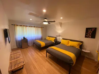 a bedroom with two beds with yellow pillows at The Mammoth Inn in Mammoth Lakes