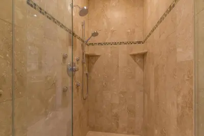 a shower with a glass door in a bathroom at Skislope-Tahoe Villa in Truckee