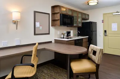 a kitchen with a table and chairs in a room at Candlewood Suites - Lodi by IHG in Lodi