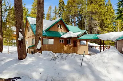 a cabin in the woods in the snow at Relaxed and Comfortable Family Gathering Home in Truckee