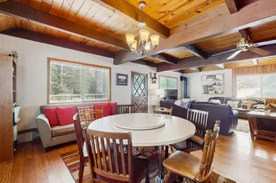 a living room with a table and chairs and a couch at Relaxed and Comfortable Family Gathering Home in Truckee
