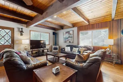 a living room with leather couches and a table at Relaxed and Comfortable Family Gathering Home in Truckee