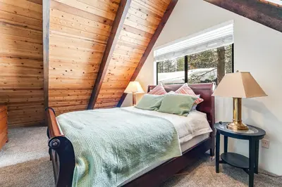 a bedroom with a bed and a window at Fairway Park Cabin in Incline Village