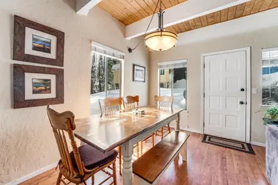 a dining room with a wooden table and chairs at Fairway Park Cabin in Incline Village