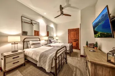 a bedroom with two beds and a desk and a ceiling fan at Steps From Heavenly Village & Gondola-Luxury 3Br Residence Condo in South Lake Tahoe
