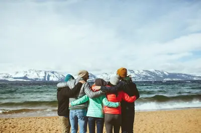 a group of people standing on the beach at Luxury Two Bedroom Residence Steps From Heavenly Village Condo in South Lake Tahoe