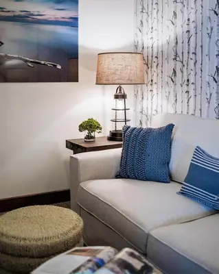 a living room with a couch and a lamp at Luxury Two Bedroom Residence Steps From Heavenly Village Condo in South Lake Tahoe
