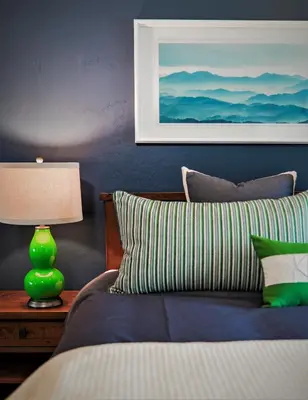 a blue bedroom with a bed with a green lamp at Luxury Two Bedroom Residence Steps From Heavenly Village Condo in South Lake Tahoe