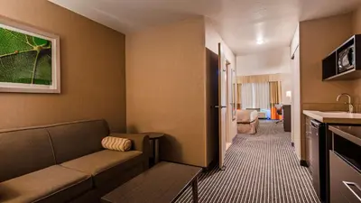 a living room with a couch in a room at Best Western Plus Rama Inn & Suites in Oakdale