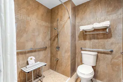 a bathroom with a toilet and a shower at Best Western Plus Yosemite Way Station in Mariposa