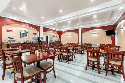 a dining room with wooden tables and chairs at Best Western Plus Yosemite Way Station in Mariposa