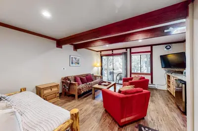 a room with a bed and two chairs and a tv at Creekside Retreat in Incline Village