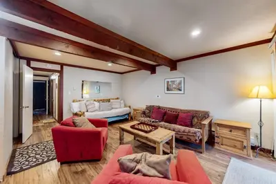 a living room with red chairs and a couch at Creekside Retreat in Incline Village