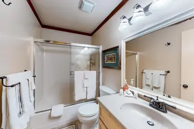 a bathroom with a sink and a toilet and a mirror at Creekside Retreat in Incline Village