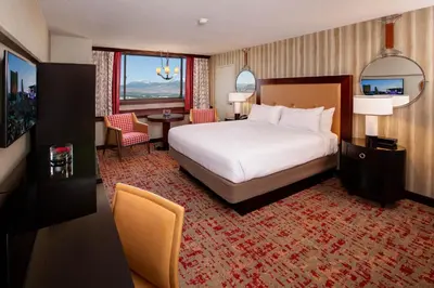 a hotel room with a bed and a table and chairs at Nugget Casino Resort in Reno