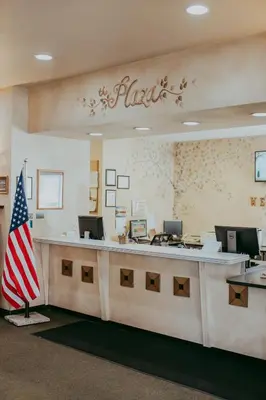 an american flag sitting in front of a reception desk at Carson City Plaza Hotel in Carson City