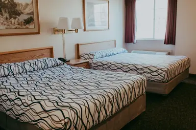 a hotel room with two beds and a window at Carson City Plaza Hotel in Carson City