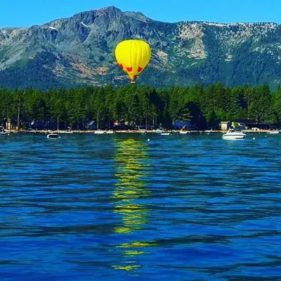 a yellow balloon flying over a large body of water at Lv12: luxury villa walk to the Beach in Glenbrook