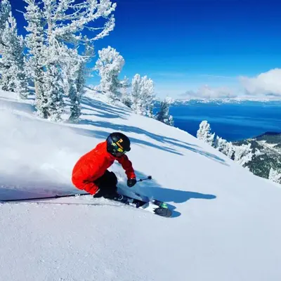 a person is skiing down a snow covered slope at Lv12: luxury villa walk to the Beach in Glenbrook