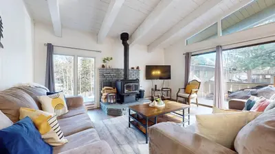a living room with a couch and a fireplace at Chateau De Montagne #6 Condo in Mammoth Lakes