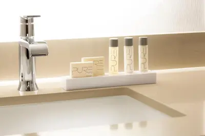 a bathroom counter with a sink with a faucet and three test tubes at Silver Legacy Reno, A Caesars Destination in Reno