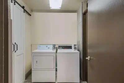 a small laundry room with a washer and dryer at Comfort Inn Gilroy in Gilroy