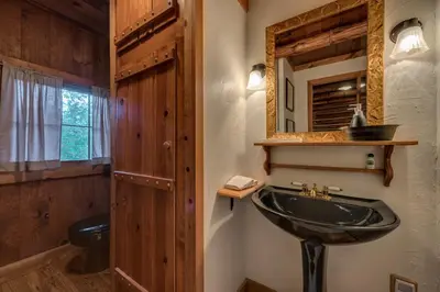 a bathroom with a sink and a mirror at The Davies Family Inn in Placerville