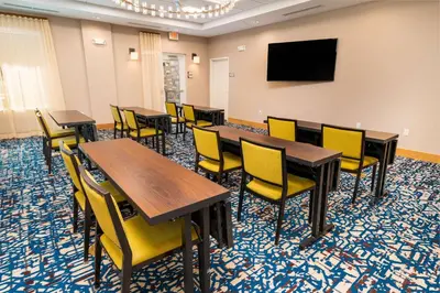 a conference room with tables and chairs and a flat screen tv at Homewood Suites By Hilton Rancho Cordova, Ca in Rancho Cordova